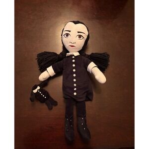 The Addams Family Wednesday Doll Plush with Yarn Braids holding headless doll